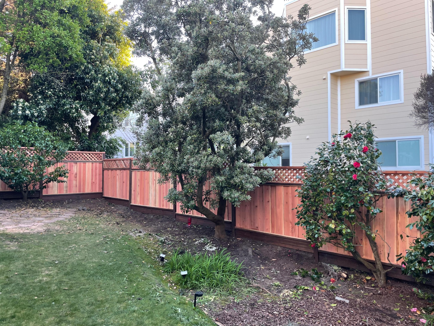 Custom cedar fence with lattice top installed by Al's Automatic Gate