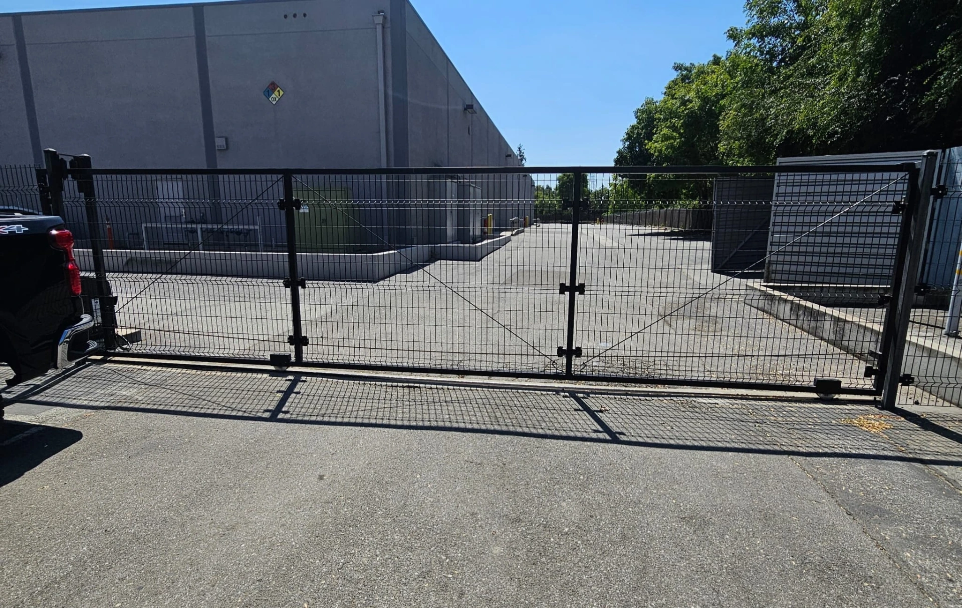 Commercial welded-mesh slide gate at a warehouse