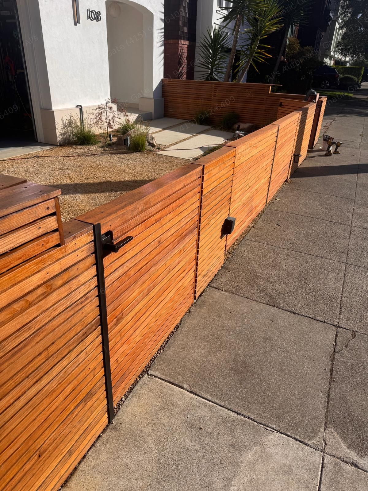 Redwood horizontal-slat front fence with a matching walk gate